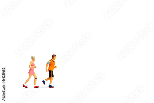 Miniature people running on white background , Healthy lifestyle and sport concepts.