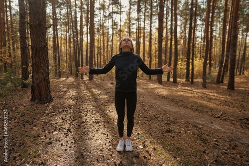 A young woman make yoga position at sunrise. in the autumn forest . High quality photo