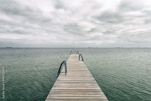 Wooden pier leading to the sea. Baltic Sea  Copenhagen. Denmark. Freedom. Trips
