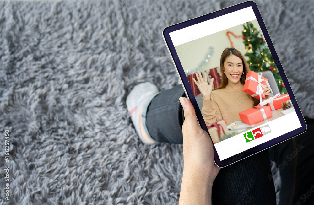 close up man using digital tablet to video call for talking and greeting with girlfriends in ornamental living room at home for christmas celebration and people technology concept	