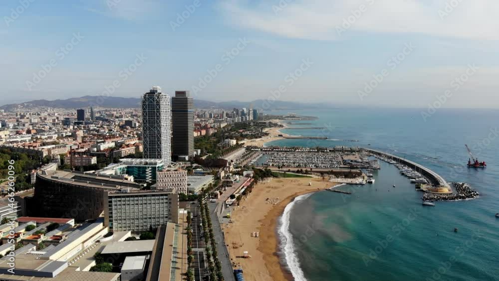 Drone shot Barcelona. Port with boats near the coast. Drone view of a vibrant swimming and sunbathing beach in Barcelona. People are relaxing on the beach. Panoramic view of the city of Barcelona. Drone shot Barcelona. Port with boats near the coast. Drone view of a vibrant swimming and sunbathing beach in Barcelona. People are relaxing on the beach. Panoramic view of the city of Barcelona.