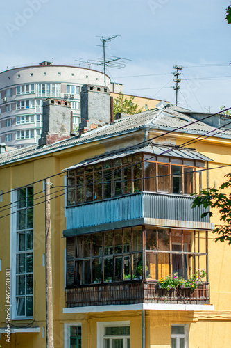 old small house on the background of a new building