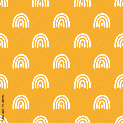 Yellow seamless pattern with white rainbows