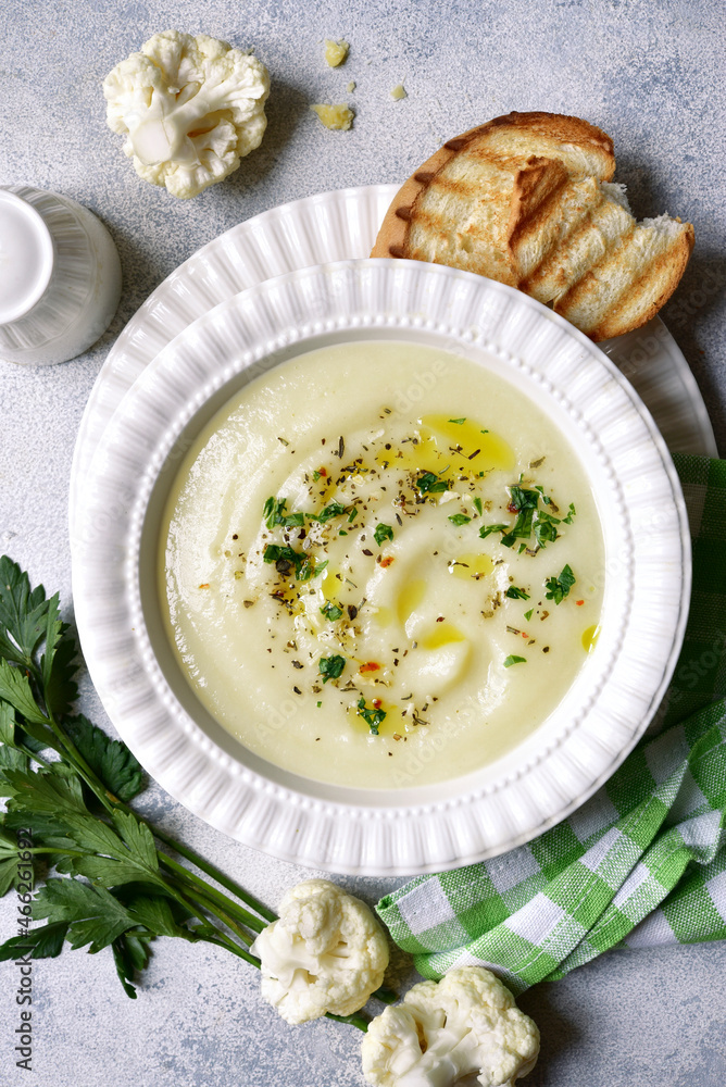 Cauliflower creamy soup with potatoes and cheese. Top view with copy space. Cauliflower creamy soup with potatoes and cheese. Top view with copy space.