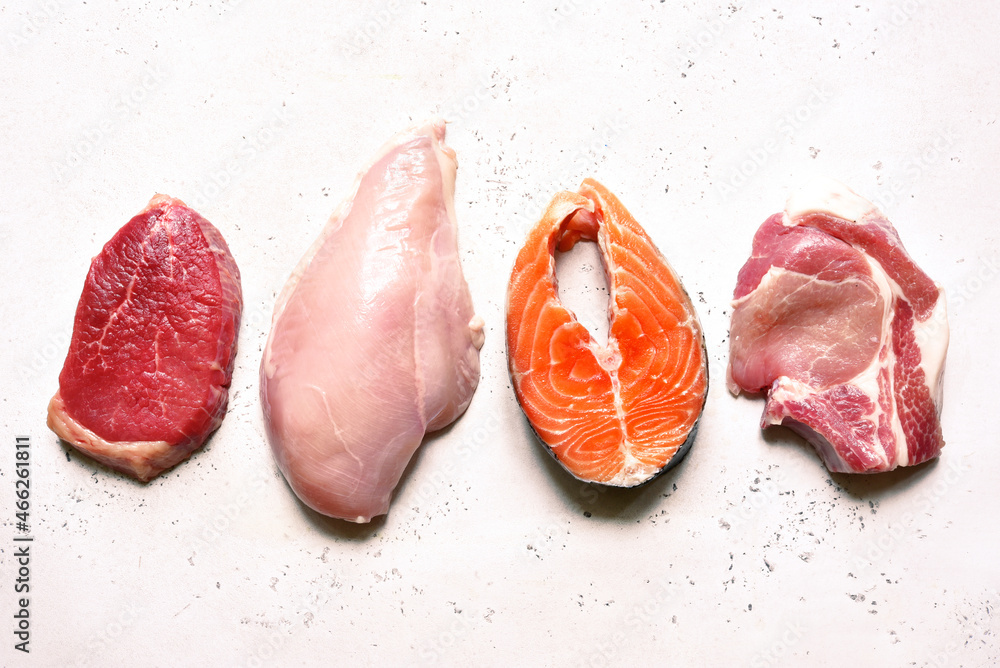 Different types of organic raw meat beef, chicken, fish and pork. Source of protein. Top view