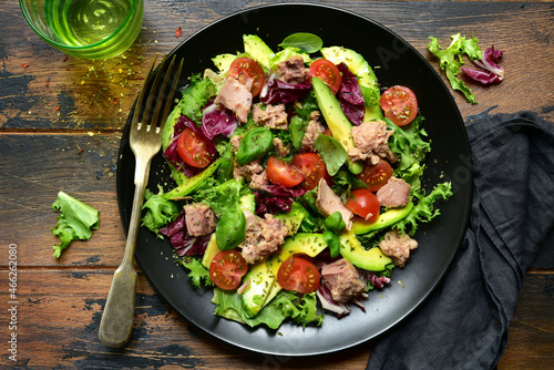Tuna salad with tomatoes and avocado. Top view with copy space.