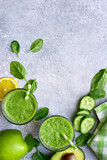 Detox smoothies from green vegetables ( cucumber, avocado, baby spinach and apple)  in a glasses. Top view with copy space.