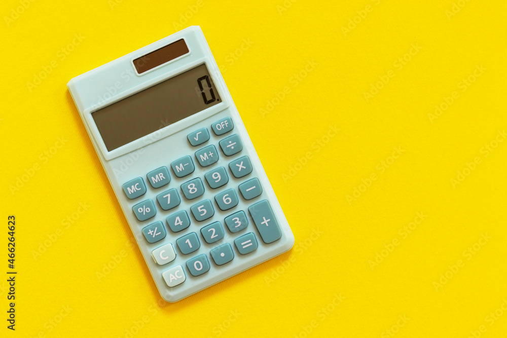 Mini calculator on yellow background. Top view, flat lay. Mini calculator on yellow background. Top view, flat lay.