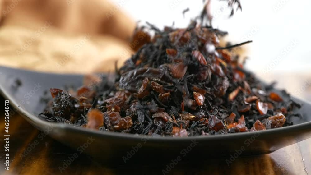 Black tea with dried cherry and hibiscus falling into a dish
Black tea with dried cherry and hibiscus falling into a dish