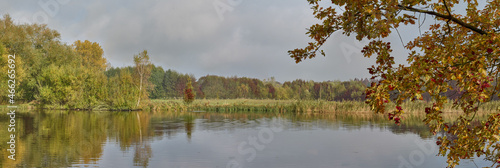 Idyllic lake in autumn with a cloudy sky