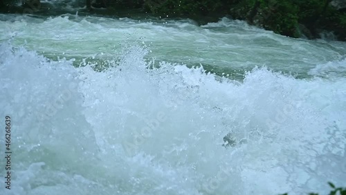 Wonderful fresh water rapids waterfalls river flowing through forest in early sprting	 photo