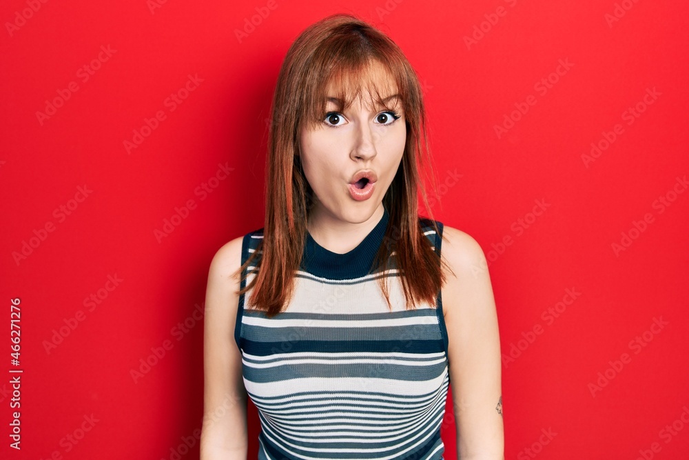 Redhead young woman wearing casual t shirt afraid and shocked with surprise expression, fear and excited face. Redhead young woman wearing casual t shirt afraid and shocked with surprise expression, fear and excited face.