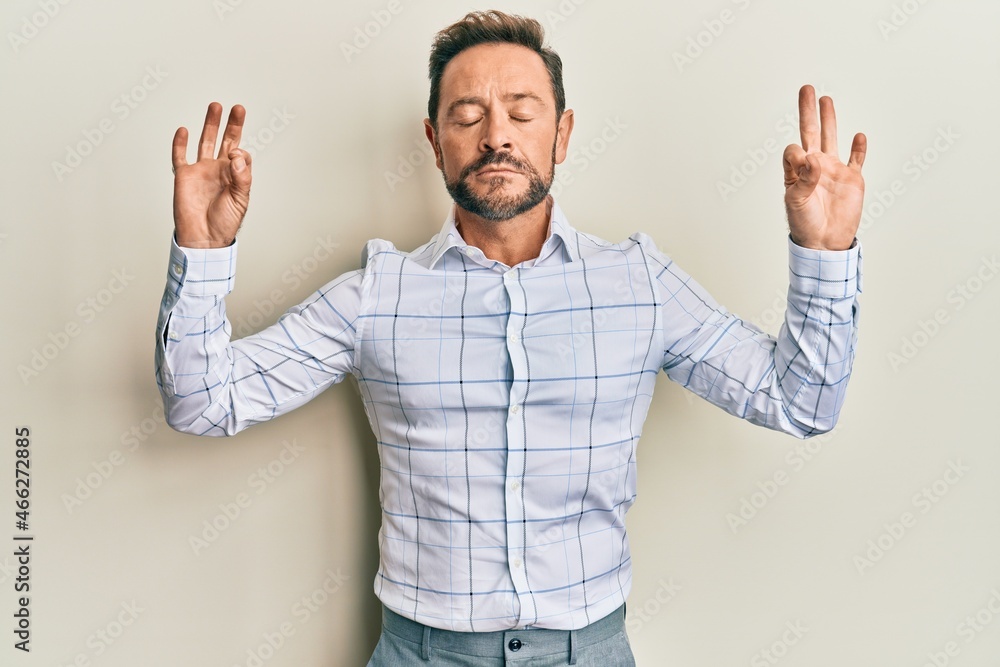 Fototapeta premium Middle age man wearing business clothes relax and smiling with eyes closed doing meditation gesture with fingers. yoga concept.