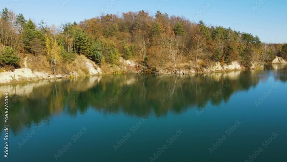 Drone View on lake with clear turquoise water and beautiful autumn forest. Aerial view on Golden trees and lake. Drone View on lake with clear turquoise water and beautiful autumn forest. Aerial view on Golden trees and lake.