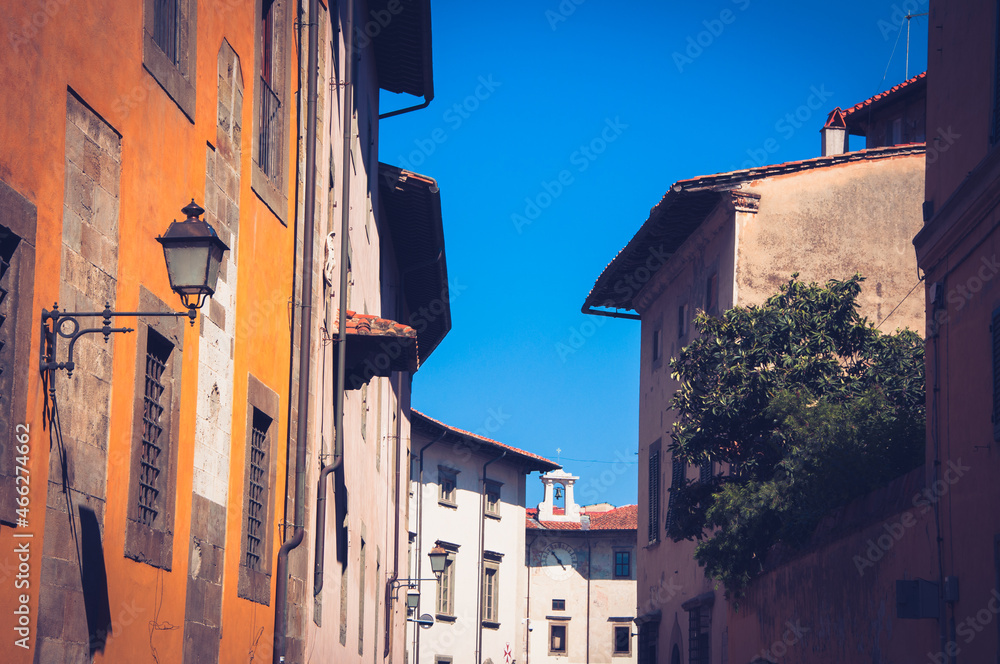 Fototapeta premium An ornate Italian Street under a bright blue sky looking upward