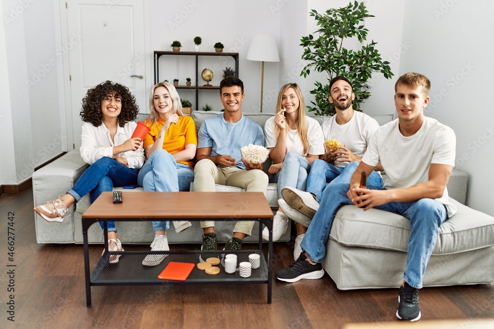 Group of young friends smiling happy watching movie at home. Group of young friends smiling happy watching movie at home.