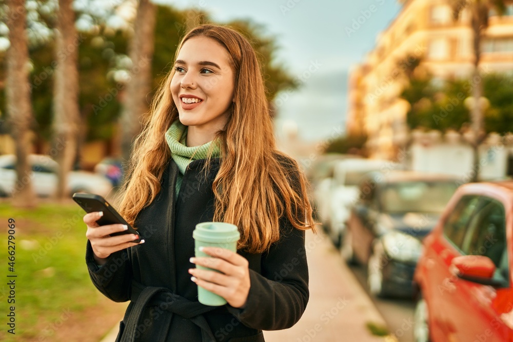 Young blonde girl using smartphone drinking coffee at the city. Young blonde girl using smartphone drinking coffee at the city.