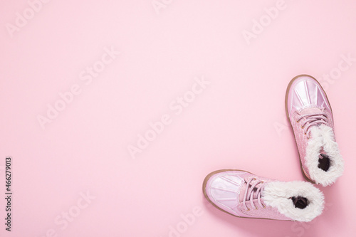 Boots for a girl on a pink background. Top view, flat lay. photo