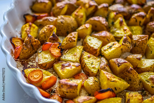 Roasted potatoes in the oven with spices and herbs close-up  food background life style  homemade potatoes recipe authentic  vegan cuisine