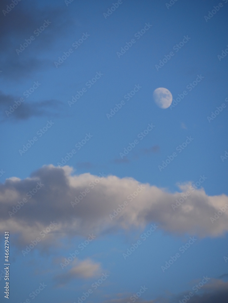 moon and clouds in beautiful sky  its blue sky color very interesting  