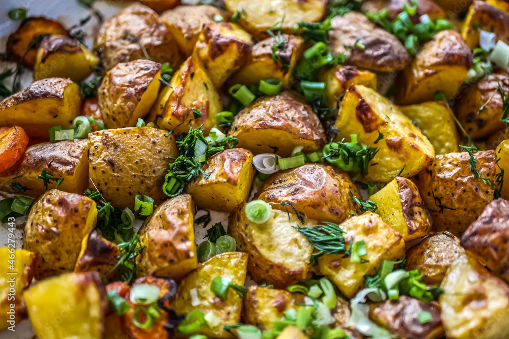 Baked potatoes in the oven with spices and herbs close-up, food background life style, homemade potatoes recipe authentic, vegan cuisine Baked potatoes in the oven with spices and herbs close-up, food background life style, homemade potatoes recipe authentic, vegan cuisine