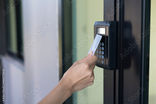 Canvastavla young woman using RFID tag key, fingerprint and access control to open the door