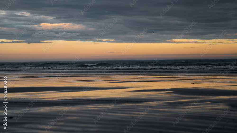 Sunset ocean reflection at Hawke Bay in New Zealand