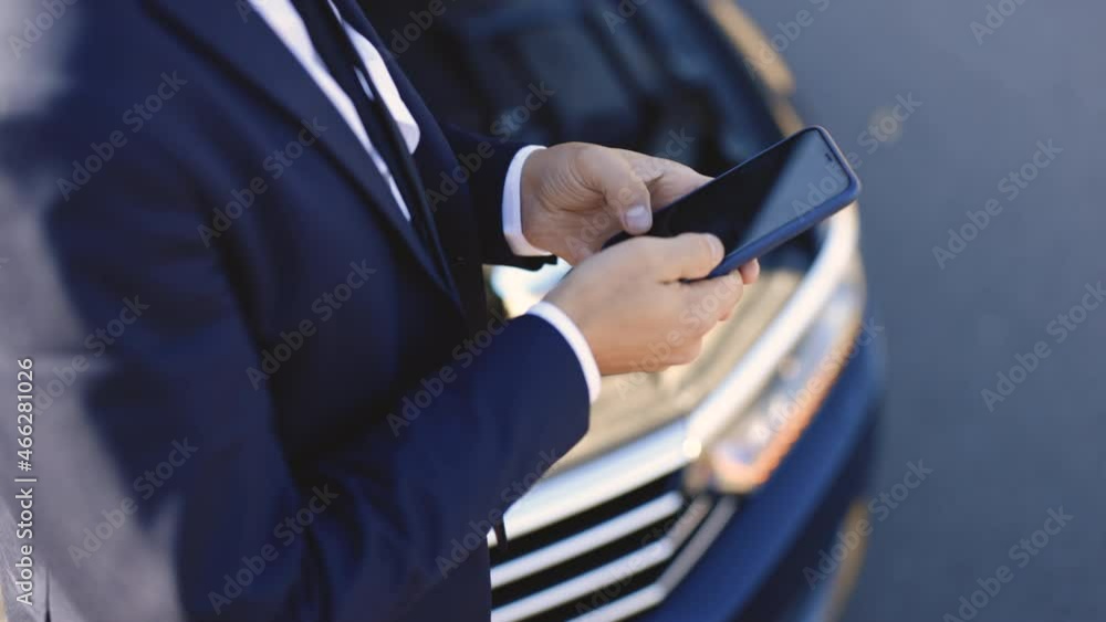 Man is using the phone in asking for help when his car is broken. Upset businessman staying on countryside road, using smartphone for calling help evacuator evacuating repair. Concept road accident Man is using the phone in asking for help when his car is broken. Upset businessman staying on countryside road, using smartphone for calling help evacuator evacuating repair. Concept road accident
