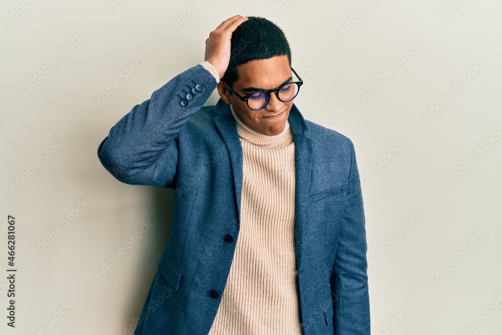 Young handsome hispanic man wearing elegant clothes and glasses confuse and wonder about question. uncertain with doubt, thinking with hand on head. pensive concept. Young handsome hispanic man wearing elegant clothes and glasses confuse and wonder about question. uncertain with doubt, thinking with hand on head. pensive concept.