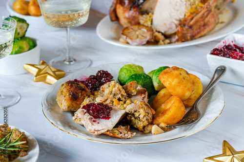 Traditional Christmas dinner with roasted turkey, apricot and pistachio stuffing, roast potatoes and cranberry sauce