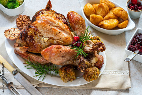 Traditional whole roasted Christmas turkey with apricot and pistachio stuffing, roast potatoes and cranberry sauce