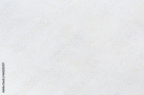 The surface is made of white fibers and gold sequins, similar to a frosty pattern