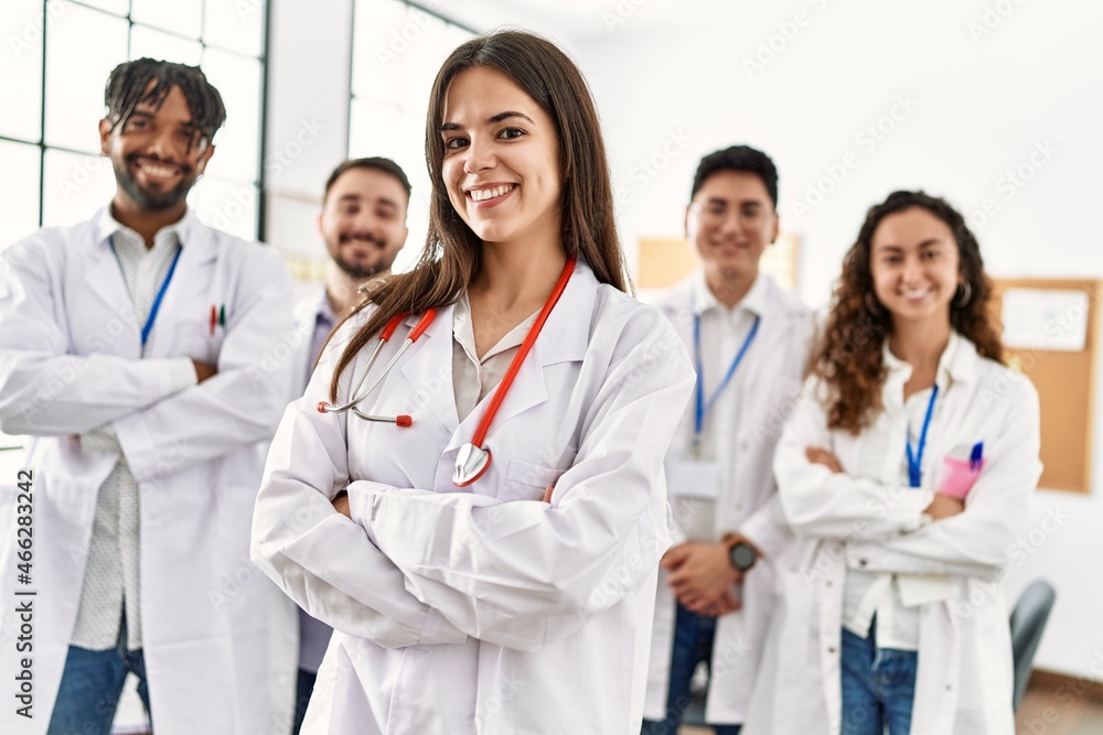 Group of young doctor smiling happy standing with arms crossed gesture at the clinic office. Group of young doctor smiling happy standing with arms crossed gesture at the clinic office.