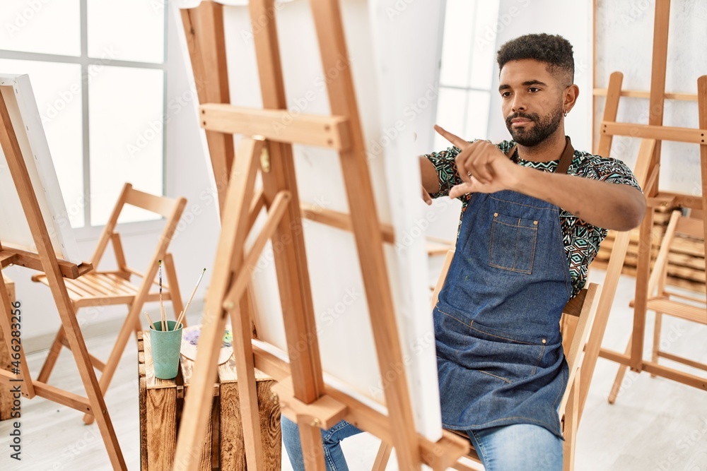 Young african american artist man concentrate painting at art studio. Young african american artist man concentrate painting at art studio.