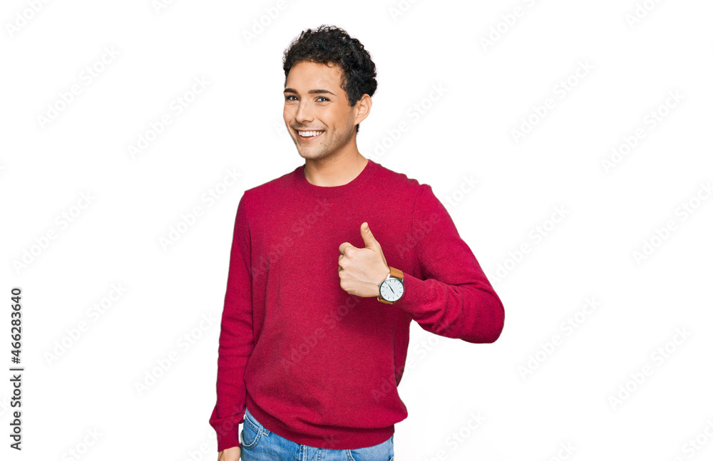 Young handsome man wearing casual clothes doing happy thumbs up gesture with hand. approving expression looking at the camera showing success. Young handsome man wearing casual clothes doing happy thumbs up gesture with hand. approving expression looking at the camera showing success.