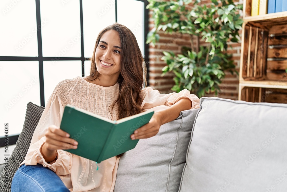 Young hispanic woman smiling confident reading book at home Young hispanic woman smiling confident reading book at home