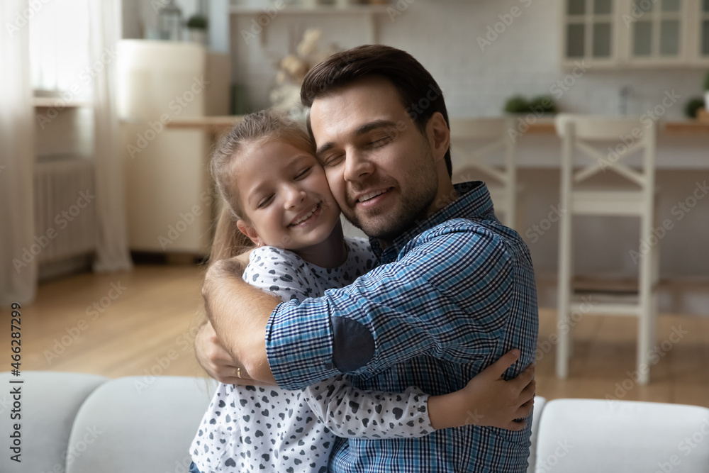 Affectionate happy young father cuddling adorable little child daughter, showing sweet tender feelings, missing after long separation, enjoying peaceful time together, family relations concept. Affectionate happy young father cuddling adorable little child daughter, showing sweet tender feelings, missing after long separation, enjoying peaceful time together, family relations concept.