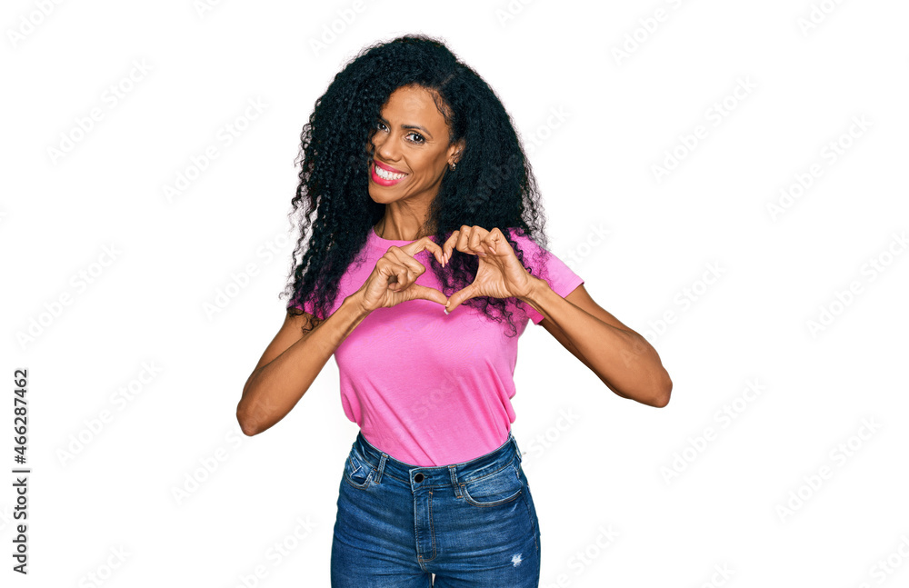 Middle age african american woman wearing casual clothes smiling in love showing heart symbol and shape with hands. romantic concept. Middle age african american woman wearing casual clothes smiling in love showing heart symbol and shape with hands. romantic concept.