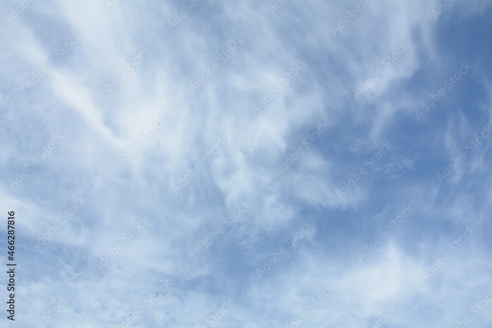 Unusual cirrus clouds in the blue sky. Beautiful sky background.