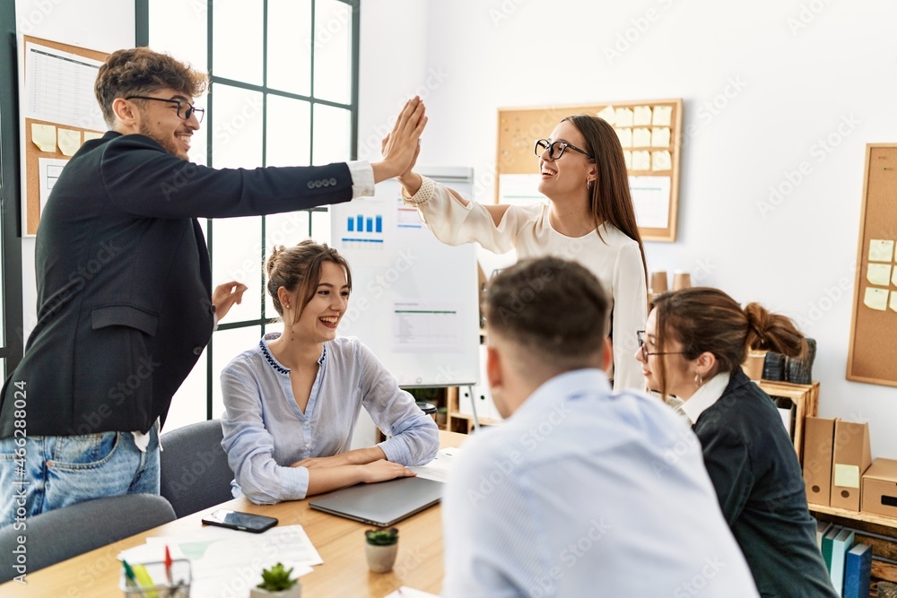 Two workers smiling happy high five during meeting at the office. Two workers smiling happy high five during meeting at the office.