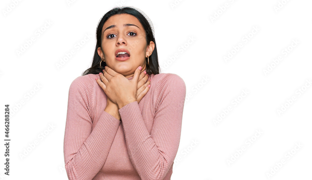 Young hispanic girl wearing casual clothes shouting and suffocate because painful strangle. health problem. asphyxiate and suicide concept. Young hispanic girl wearing casual clothes shouting and suffocate because painful strangle. health problem. asphyxiate and suicide concept.