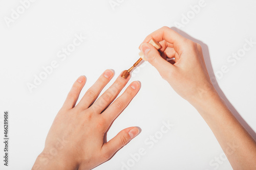 Female hands apply nail polish at home