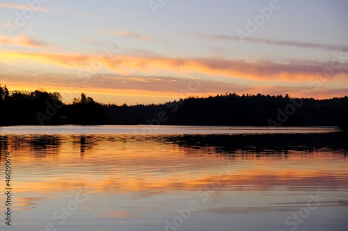 Beautiful scenery of sunrise over lake. © Iwona