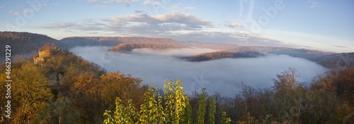 Panorama of an autumn sunrise with fog in the valley over the ruins of Nový Hrádek Castle and Dyje river in the Podyjí National Park