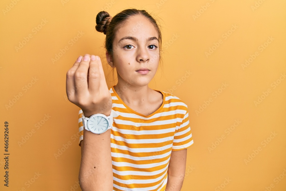 Beautiful brunette little girl wearing casual striped t shirt doing italian gesture with hand and fingers confident expression Beautiful brunette little girl wearing casual striped t shirt doing italian gesture with hand and fingers confident expression