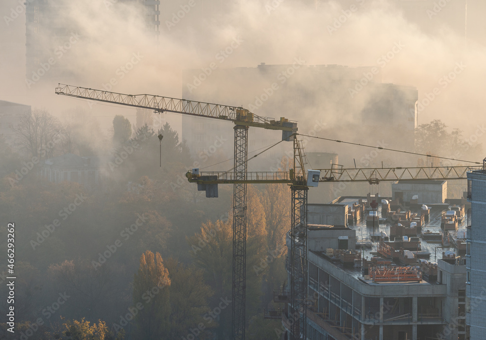 Construction site in fog at dawn