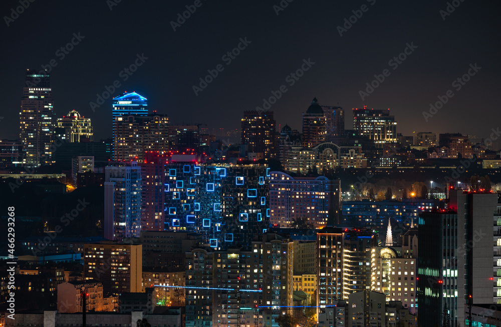 City skyline in twilight, illuminated skyscrapers in downtown