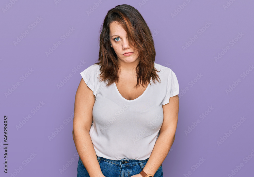 Young plus size woman wearing casual white t shirt looking sleepy and tired, exhausted for fatigue and hangover, lazy eyes in the morning. Young plus size woman wearing casual white t shirt looking sleepy and tired, exhausted for fatigue and hangover, lazy eyes in the morning.