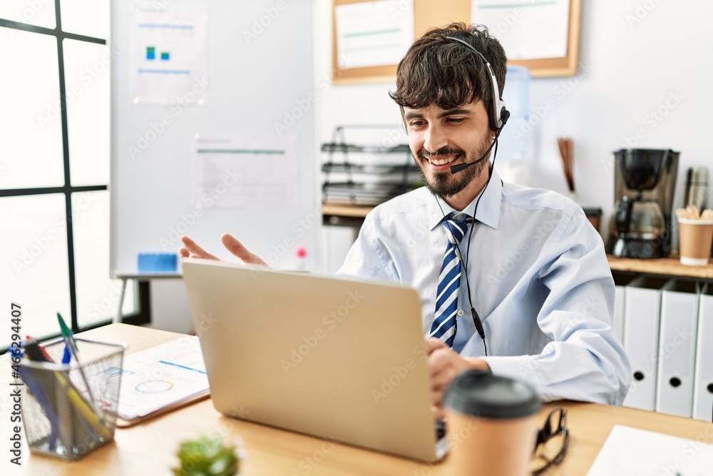 Young hispanic call center agent man smiling happy working at the office. Young hispanic call center agent man smiling happy working at the office.