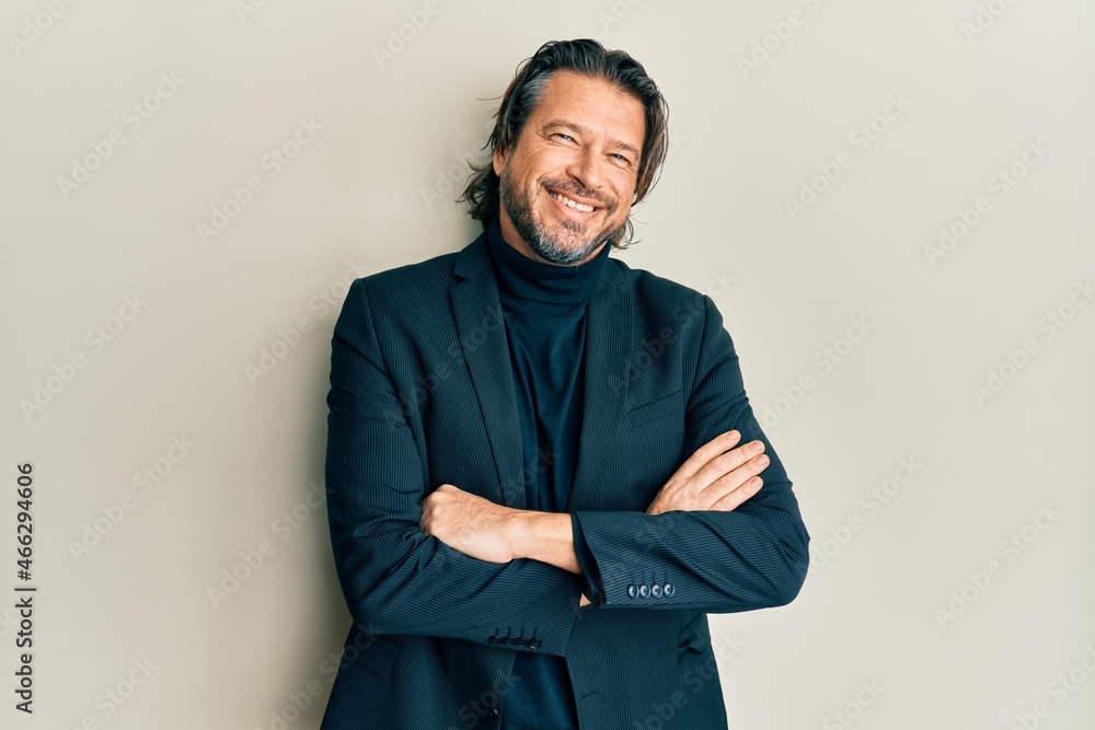 Middle age handsome man wearing business clothes happy face smiling with crossed arms looking at the camera. positive person. Middle age handsome man wearing business clothes happy face smiling with crossed arms looking at the camera. positive person.
